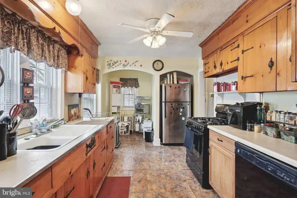 a kitchen with stainless steel appliances kitchen island granite countertop a sink and cabinets