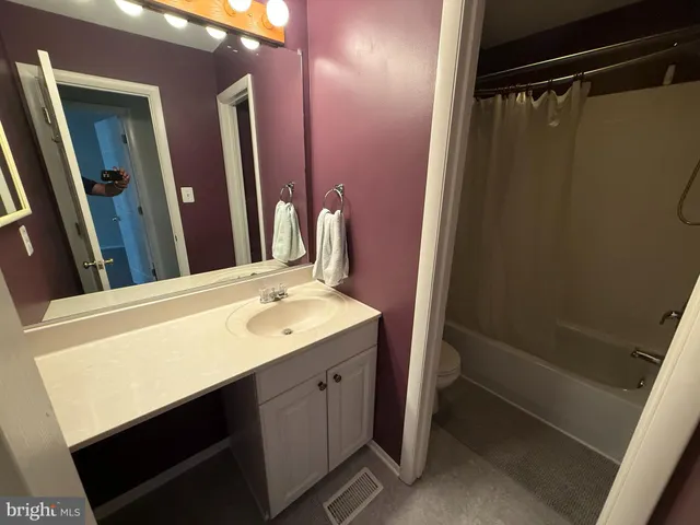 a bathroom with a sink a mirror and a shower