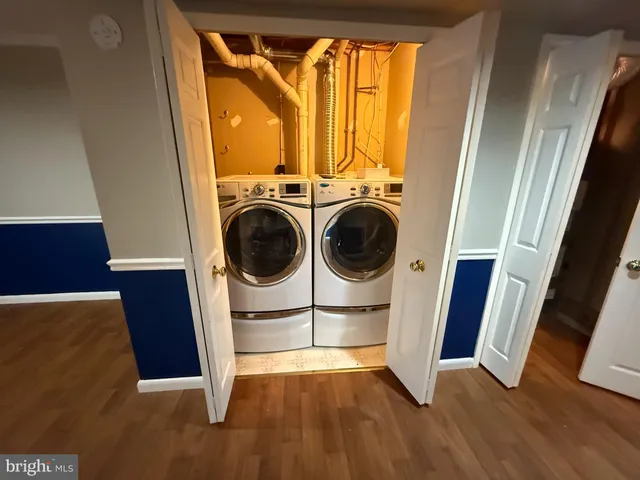 a view of a hallway with washer and dryer