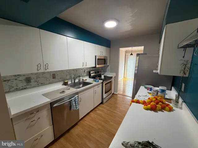 a kitchen with a sink stove and refrigerator