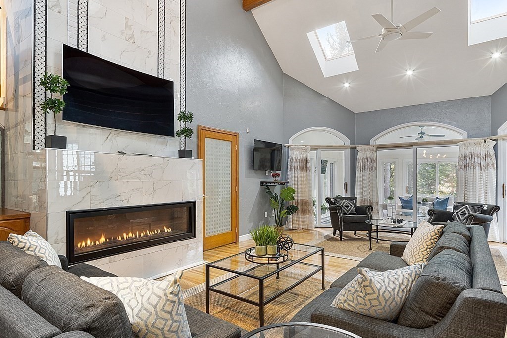 24 Powers Road Andover, MA 01810 - Photo 11 of 42 a living room with furniture a fireplace and a flat screen tv