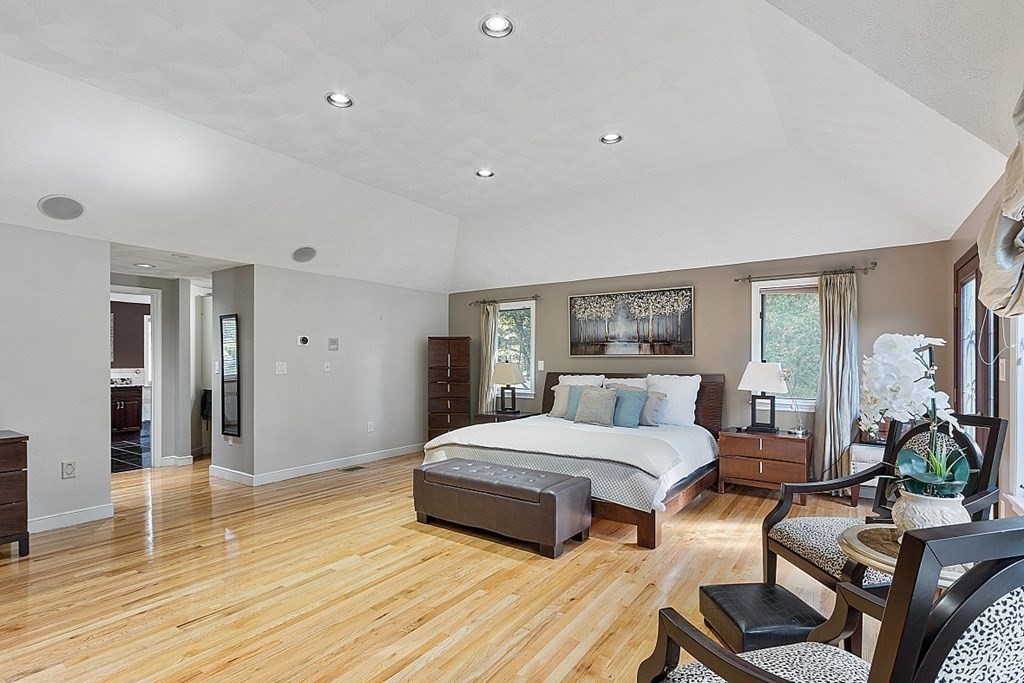 24 Powers Road Andover, MA 01810 - Photo 19 of 42 a bedroom with a bed and wooden floor