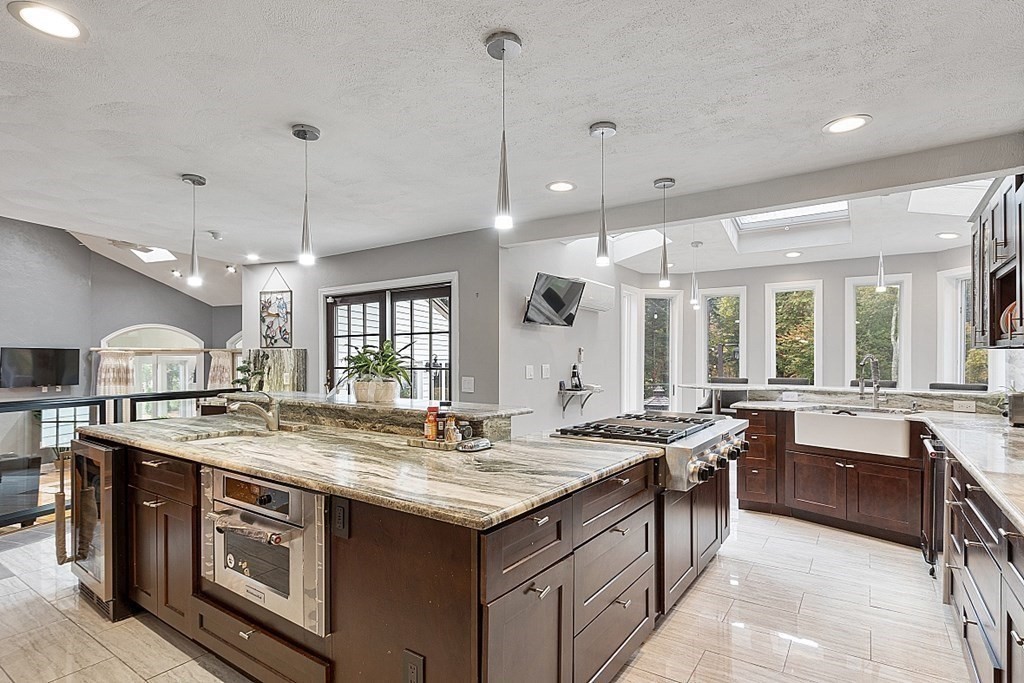24 Powers Road Andover, MA 01810 - Photo 6 of 42 a open kitchen with stainless steel appliances granite countertop a stove and a sink