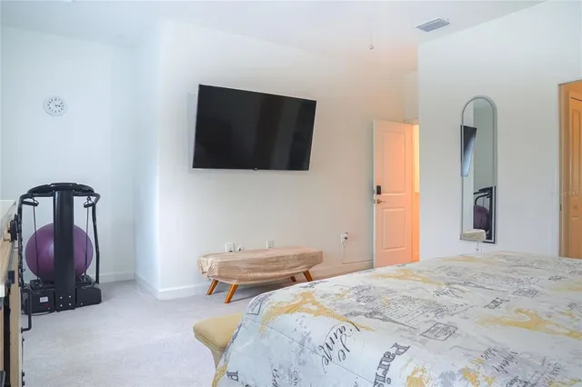 a bedroom with bed and flat screen tv