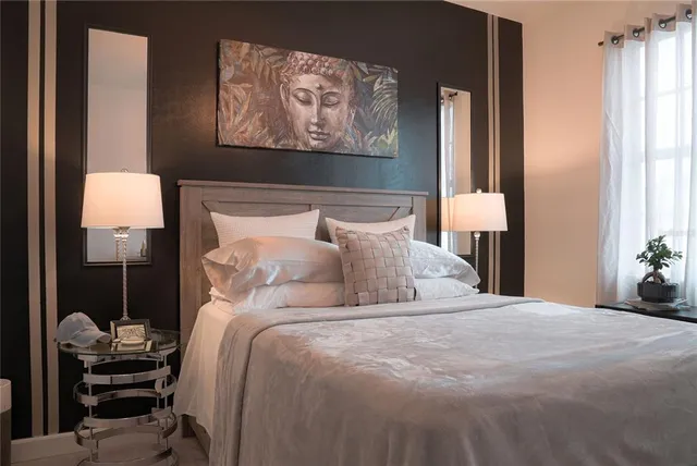 a bedroom with a bed and a painting on the wall