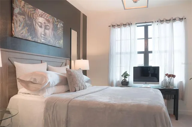 a bedroom with a bed and a tv