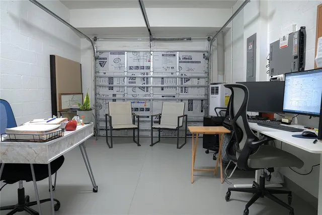 a workspace with furniture and chandelier