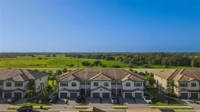 a view of a big house with a big yard