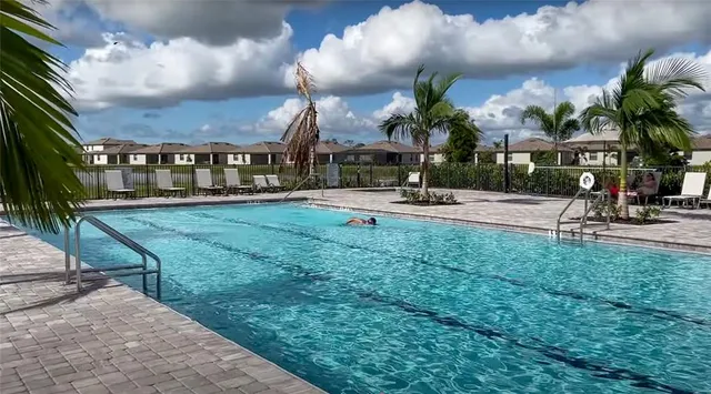 a view of a patio with a table and chairs under an umbrella
