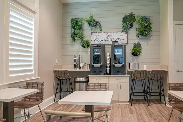 a living room with furniture a flat screen tv and a window