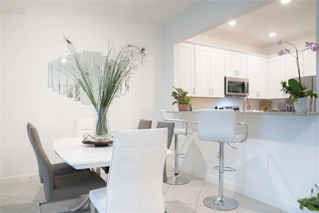 a living room with furniture a potted plant and a chandelier