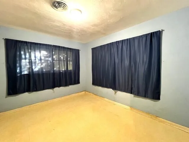 a view of a big room with closet and windows
