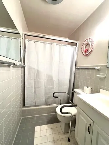 a bathroom with a toilet a sink and a shower