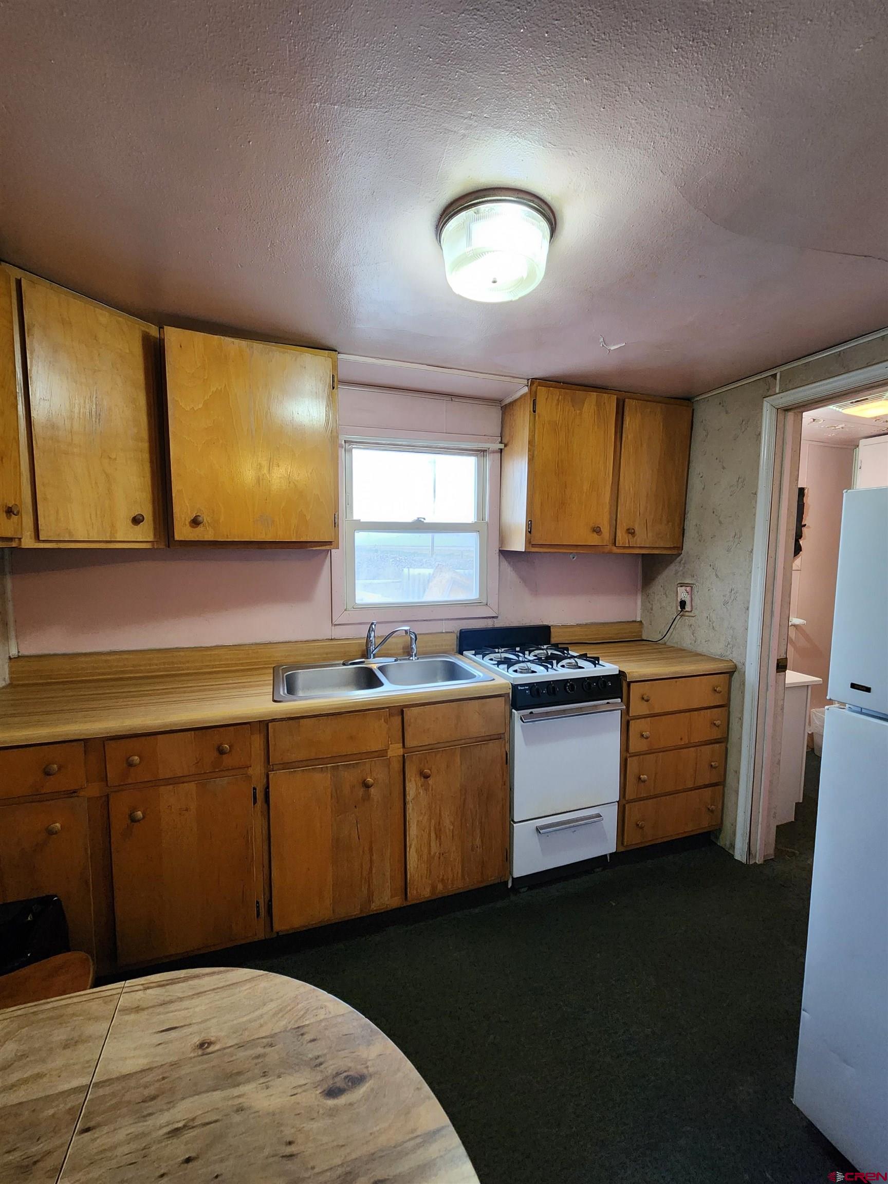 11977 US Highway 285 Center, CO 81125 - Photo 12 of 16 a kitchen with stainless steel appliances granite countertop a sink and cabinets
