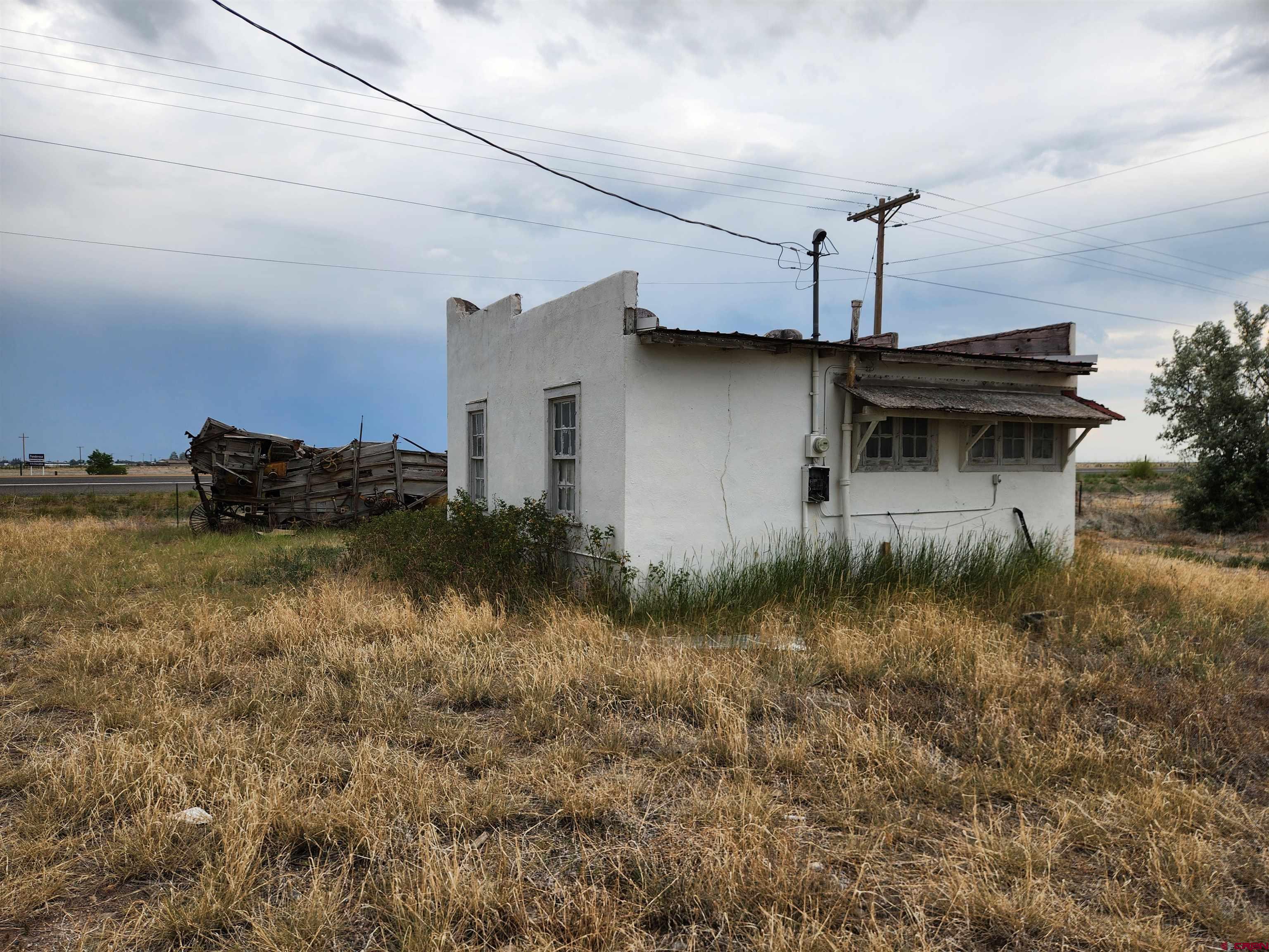 11977 US Highway 285 Center, CO 81125 - Photo 16 of 16 a yellow house with green field in front of it