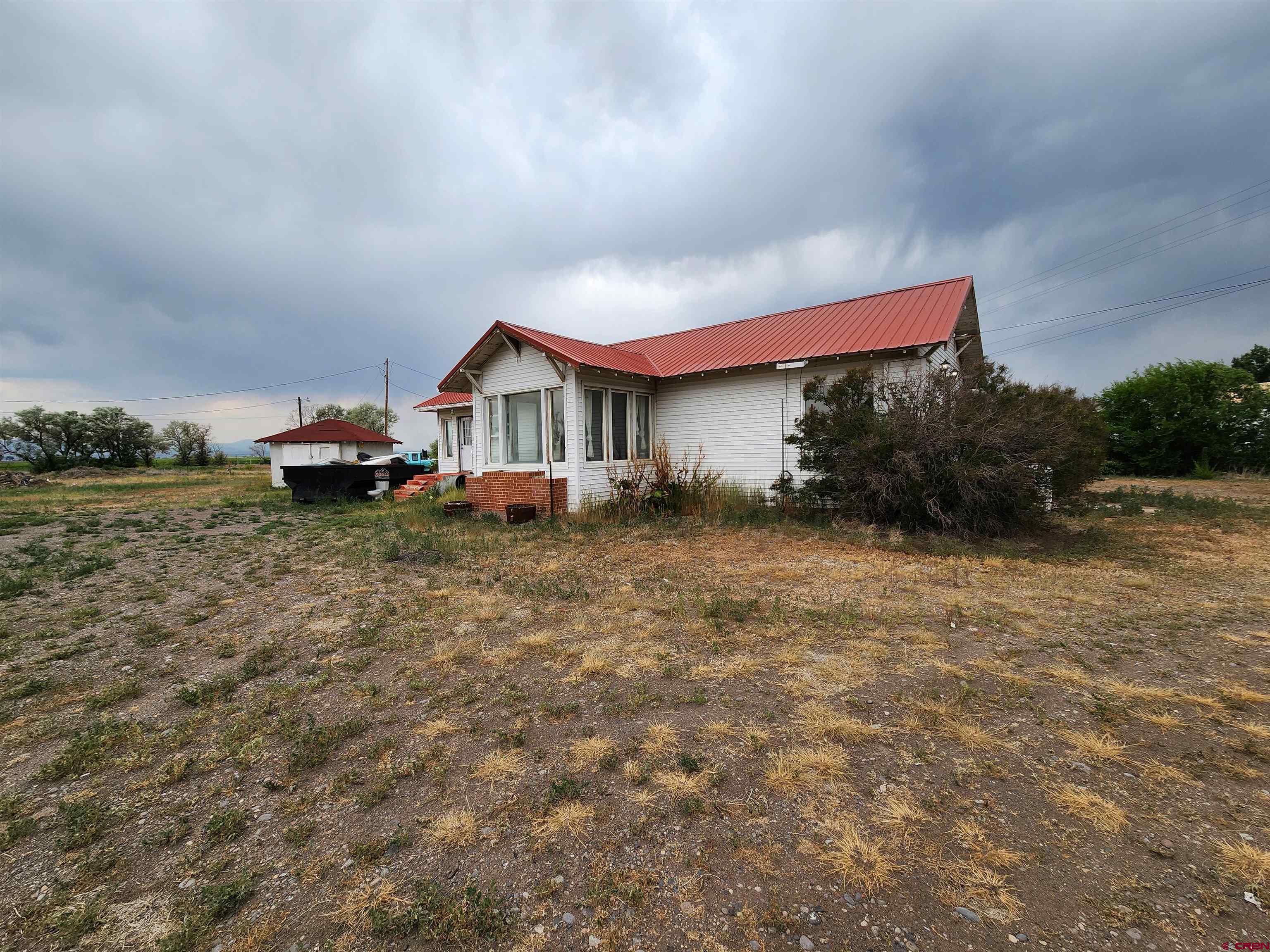 11977 US Highway 285 Center, CO 81125 - Photo 2 of 16 a house view with a garden space