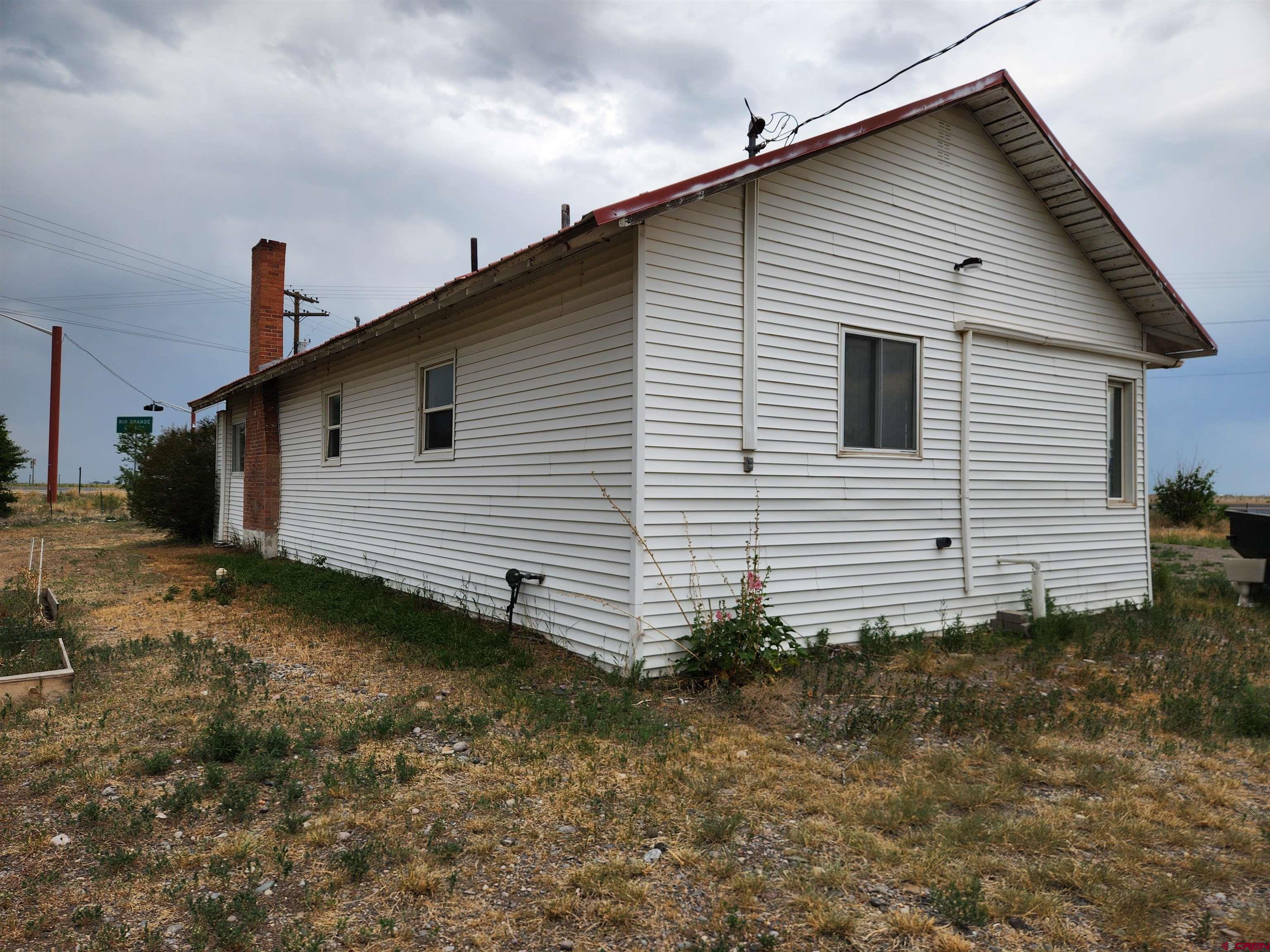 11977 US Highway 285 Center, CO 81125 - Photo 3 of 16 a view of a house with a yard