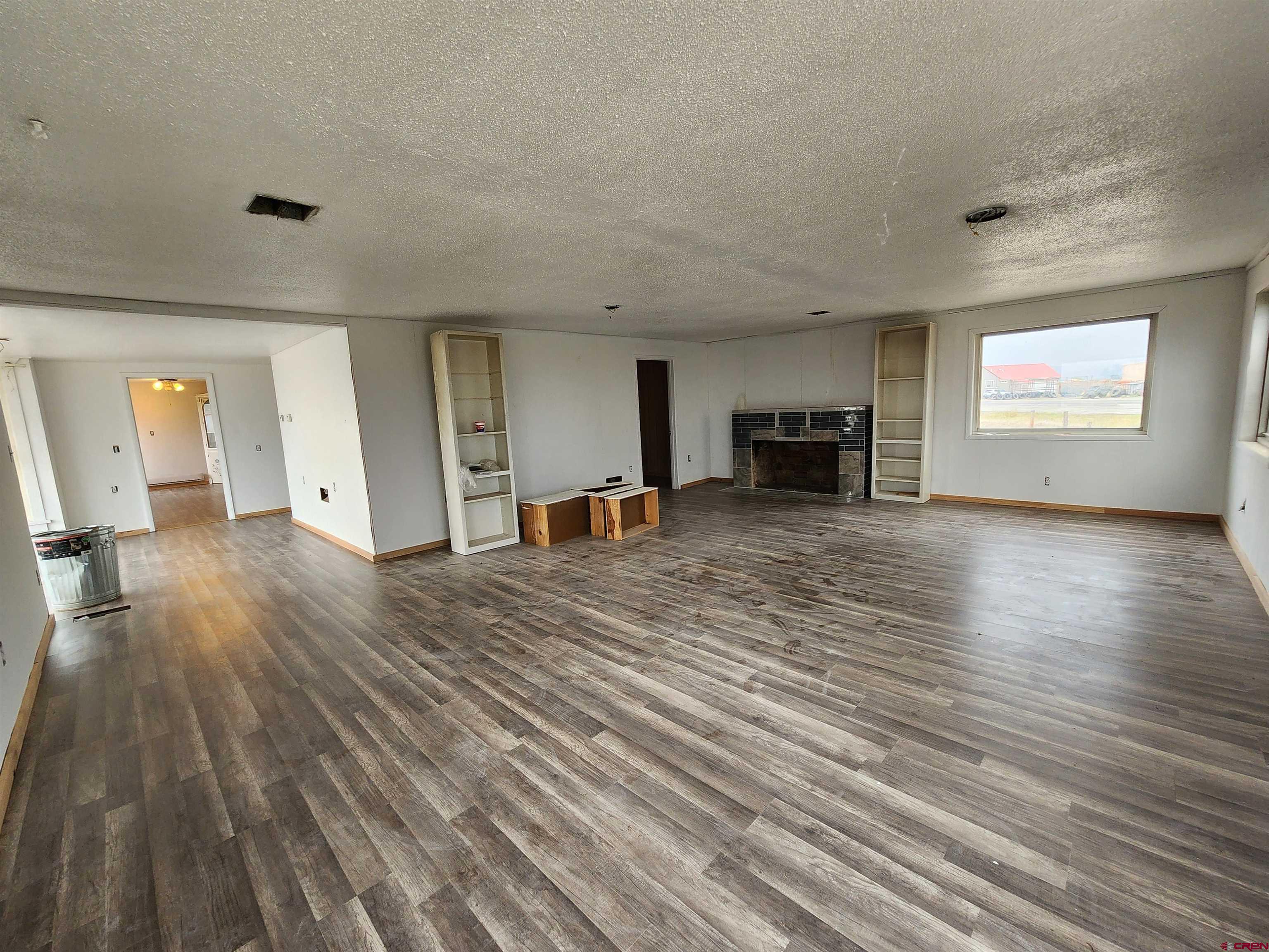 11977 US Highway 285 Center, CO 81125 - Photo 4 of 16 a view of a livingroom with furniture an empty room and fire place