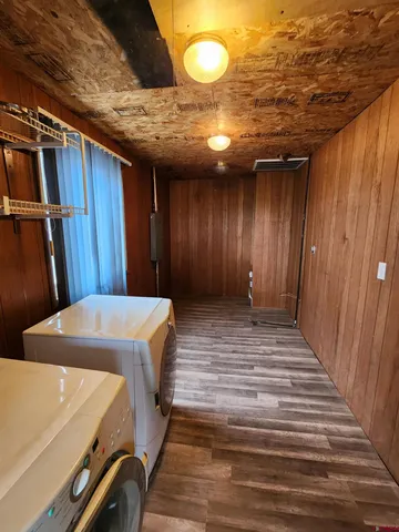 a view of a room with wooden floor