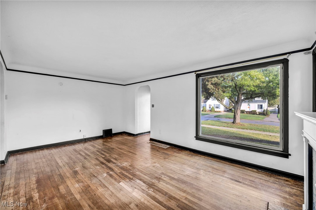 8017 Ackley Road Parma, OH 44129 - Photo 7 of 43 Unfurnished room with arched walkways and light wood finished floors