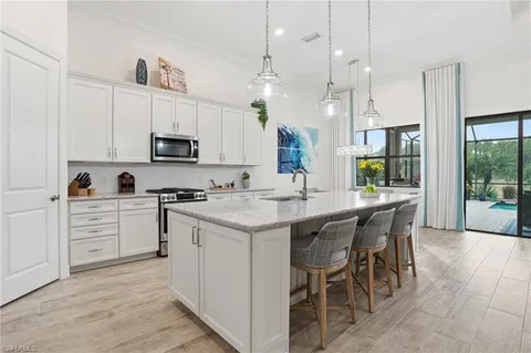 a kitchen with kitchen island granite countertop wooden cabinets and white appliances