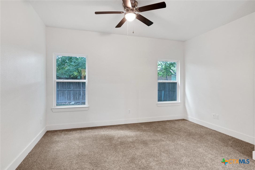 1920 Royal Loop Belton, TX 76513 - Photo 13 of 15 an empty room with a window and a ceiling fan