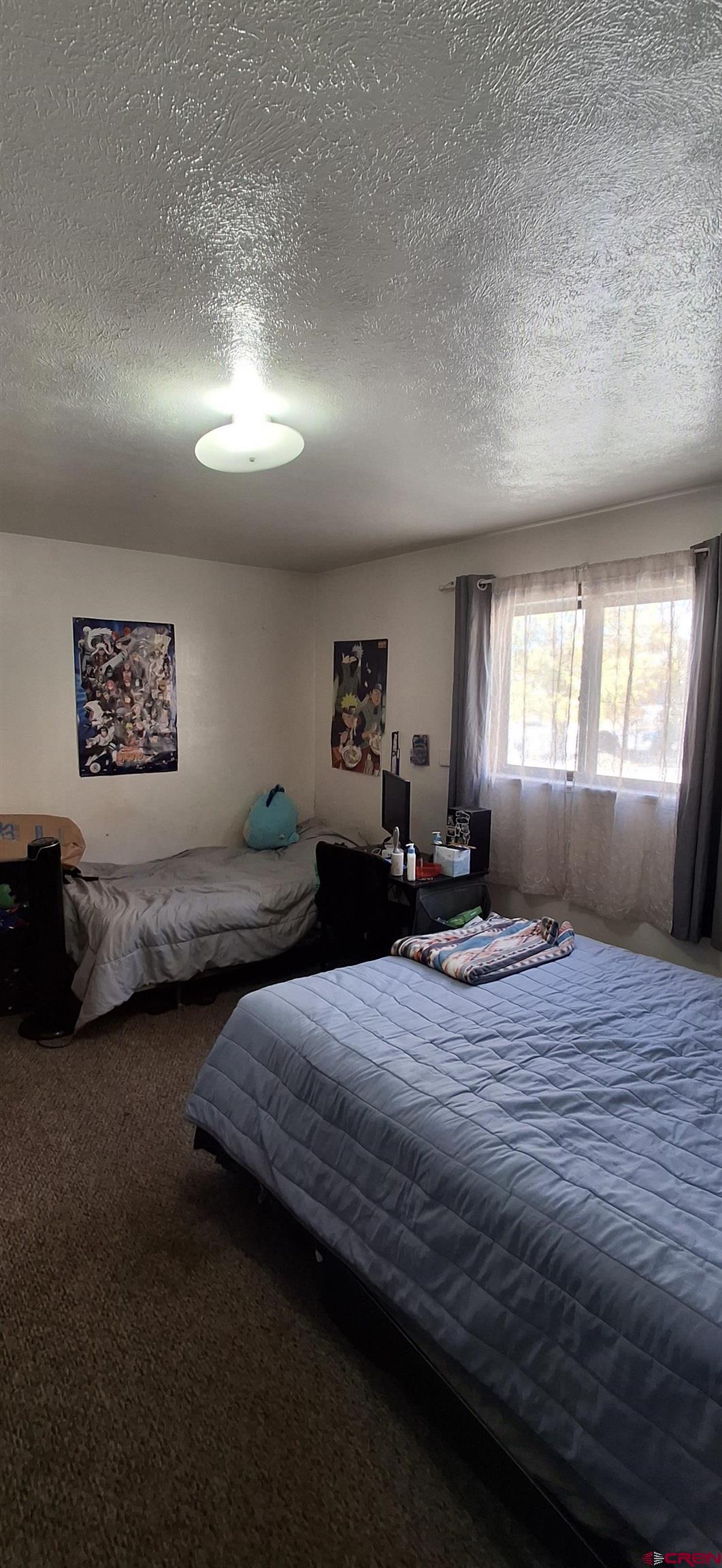 304 North 9th Street, Unit 3A Gunnison, CO 81230 - Photo 4 of 5 a bedroom with double bed and a large window