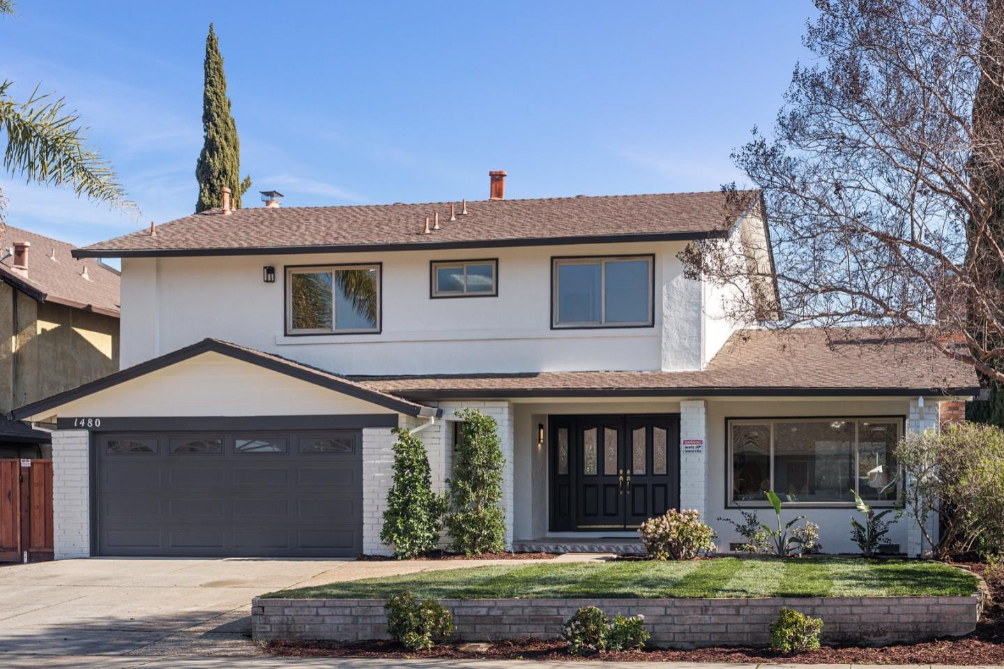 1480 Mallard Way Sunnyvale, CA 94087 - Photo 2 of 5 a front view of a house with a yard and garage