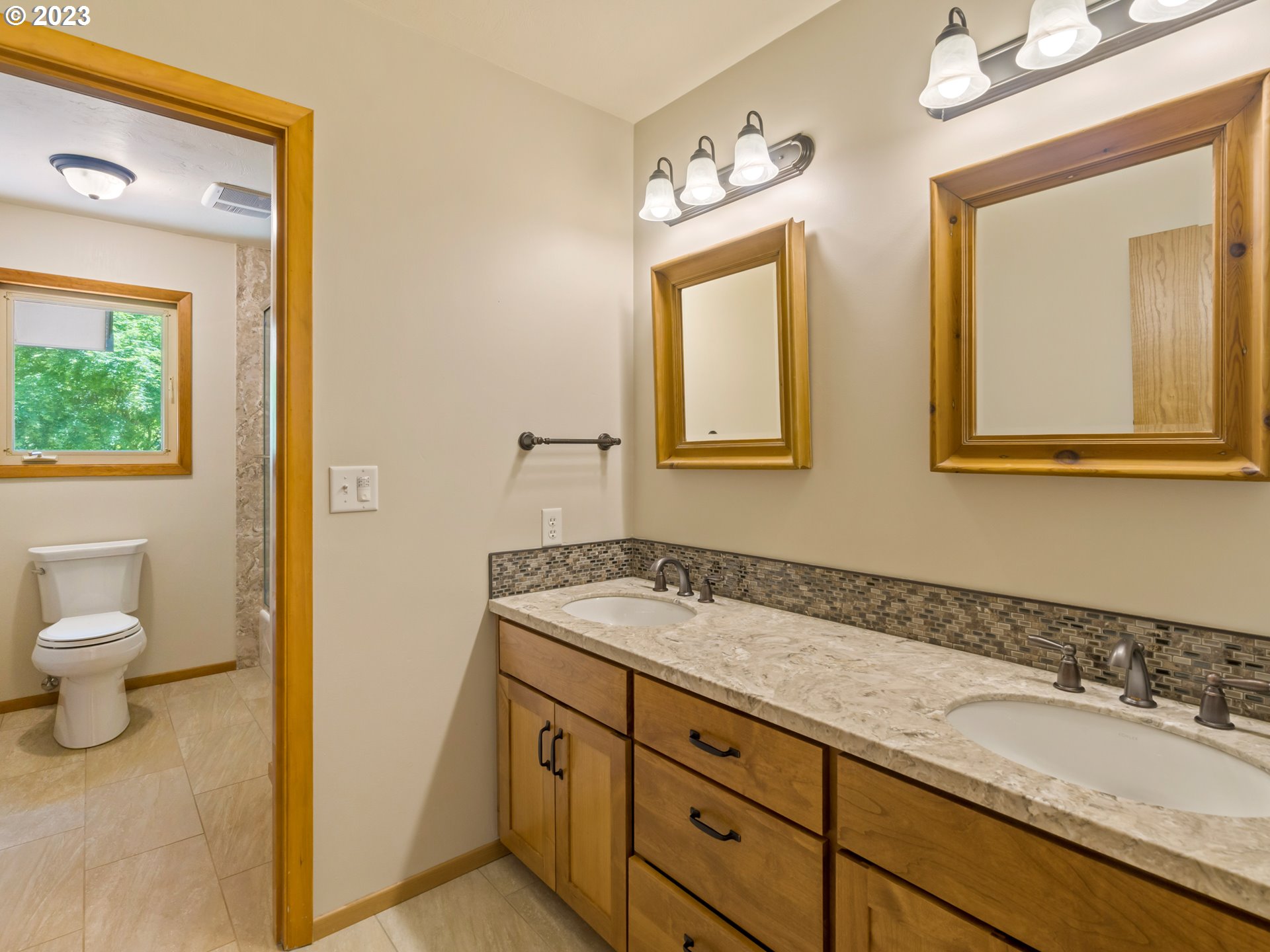 88601 Ermi Bee Road Springfield, OR 97478 - Photo 31 of 48 a bathroom with a granite countertop sink mirror and a toilet
