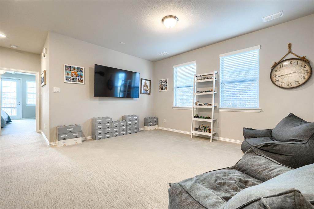 1436 Pebble Way Allen, TX 75013 - Photo 17 of 35 a living room with furniture and a flat screen tv