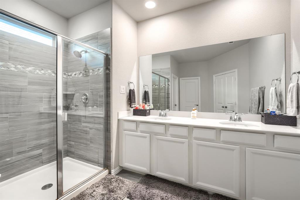 1436 Pebble Way Allen, TX 75013 - Photo 24 of 35 a bathroom with a double vanity sink mirror and shower