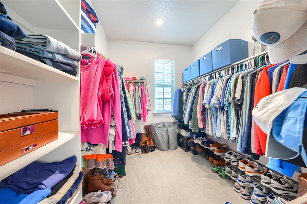 1436 Pebble Way Allen, TX 75013 - Photo 25 of 35 a view of walk in closet with clothes and shoes