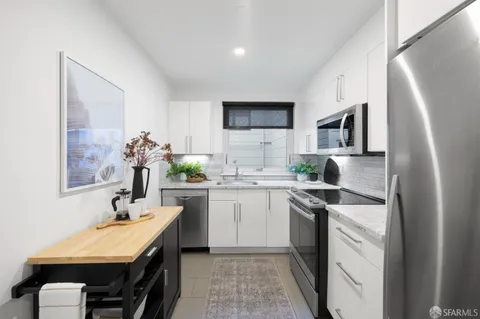 a kitchen with a sink stove and refrigerator