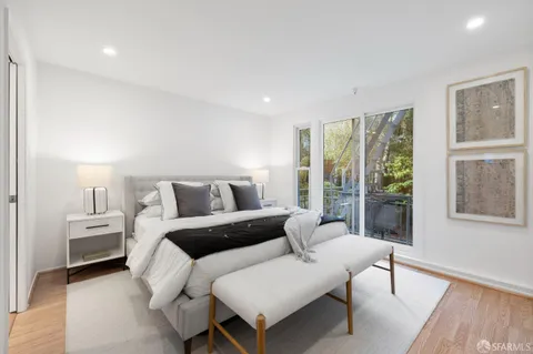 a bedroom with furniture and a large window