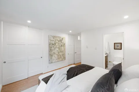 a bedroom with a large bed and a window