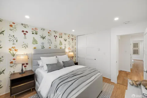 a bedroom with bed and wooden floor