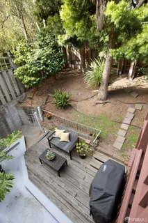 a view of yard from deck with patio