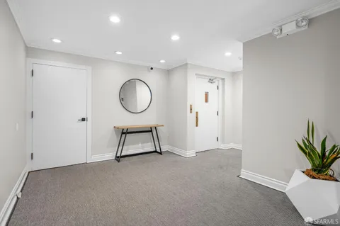 a view of a room with a potted plant and a ceiling fan