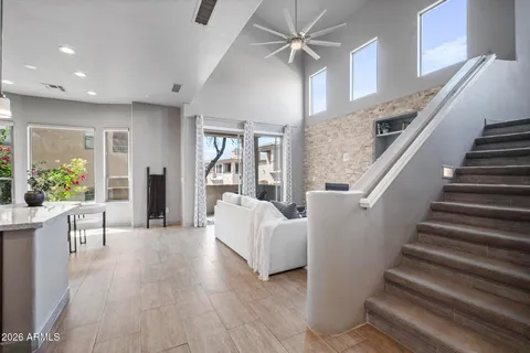 a living room with furniture and a chandelier