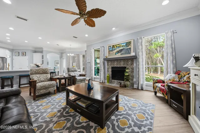 a living room with furniture fireplace and flat screen tv
