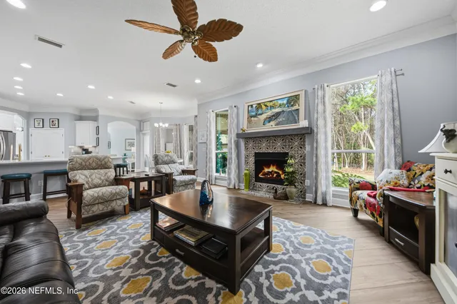 a living room with furniture fireplace and window