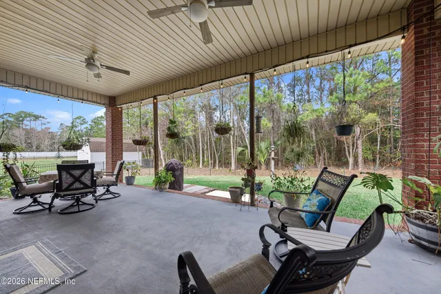 a living room with patio furniture and a garden