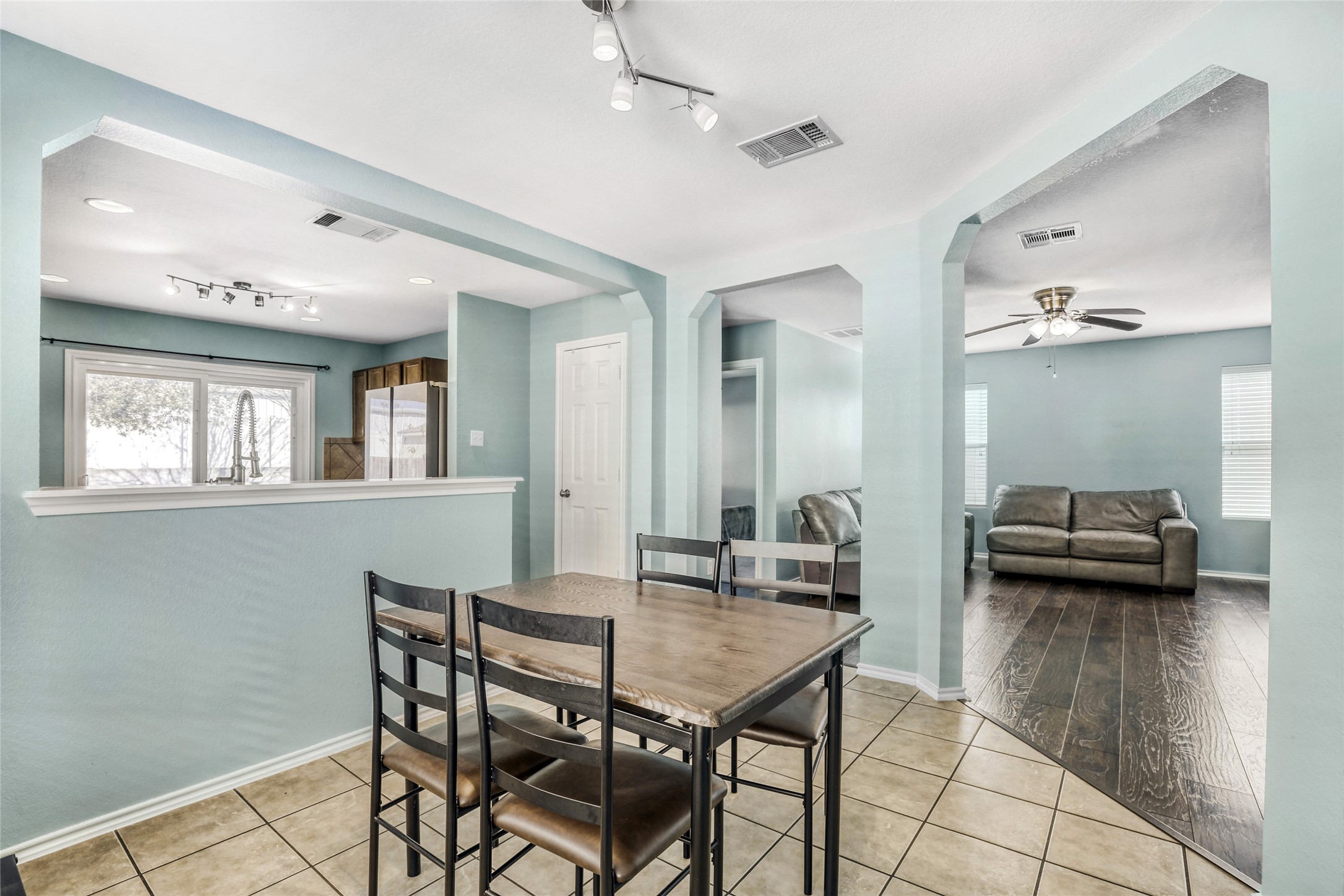 5624 Colinton Avenue Austin, TX 78754 - Photo 19 of 38 Dining room with arched walkways, rail lighting, light tile patterned floors, and ceiling fan
