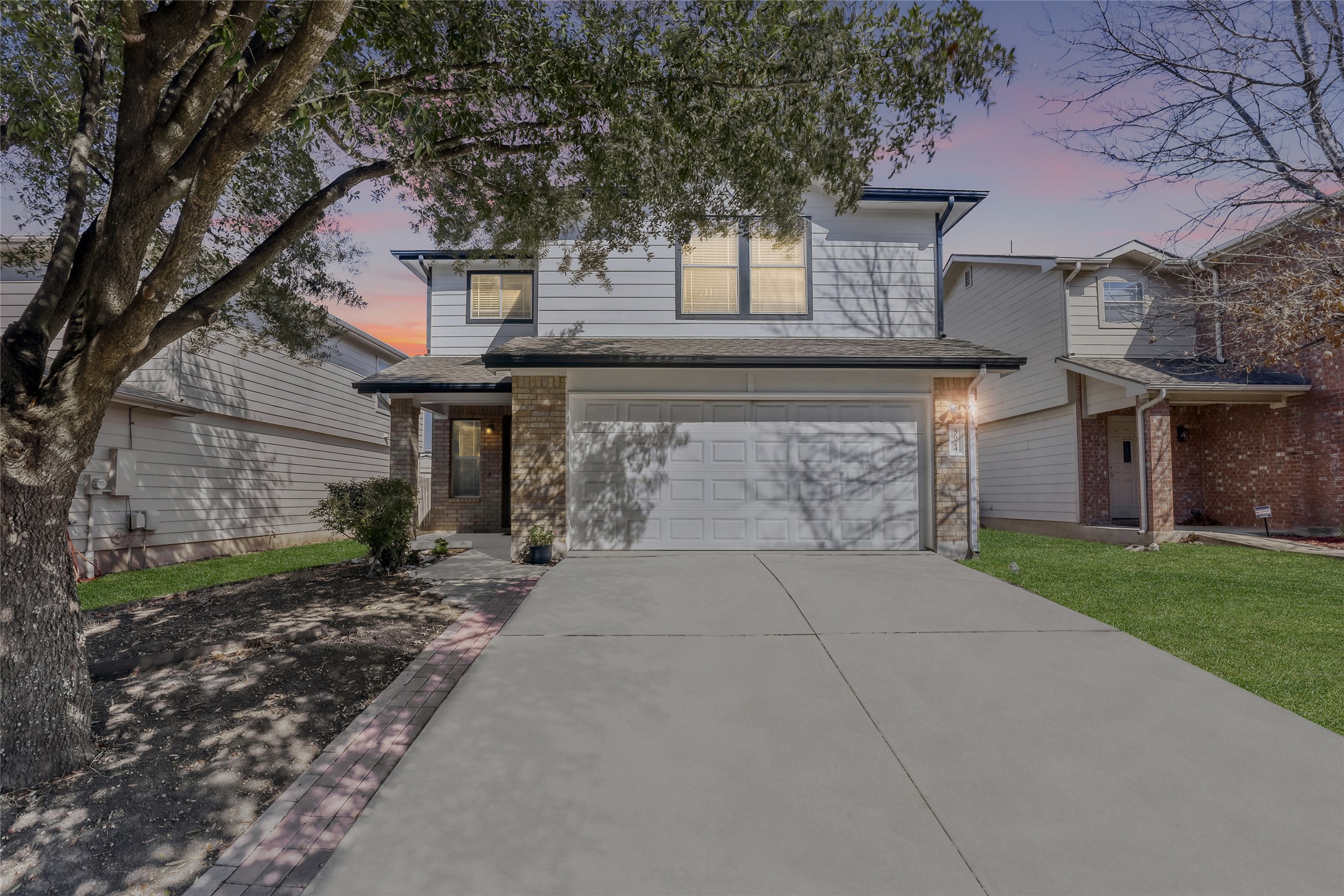 5624 Colinton Avenue Austin, TX 78754 - Photo 38 of 38 Traditional home with brick, Hardi-board siding, a garage, and driveway