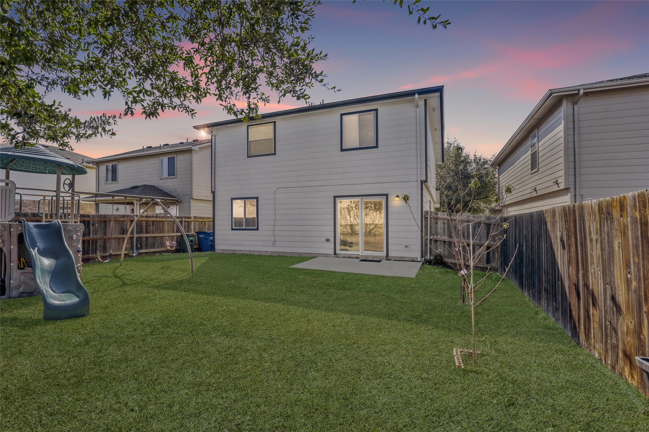 5624 Colinton Avenue Austin, TX 78754 - Photo 6 of 38 Rear view of house with a patio area, a playground, and a fenced backyard