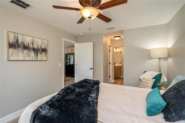 a bed room with a bed and a lamp