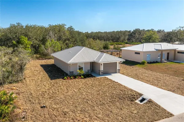 an aerial view of a house with a yard