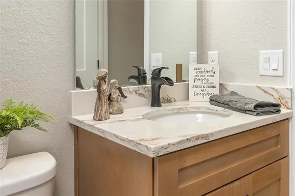 a bathroom with a toilet a sink and a mirror