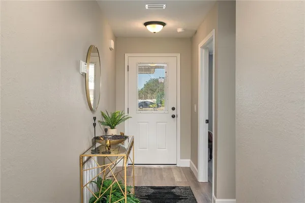 a bathroom with a sink a mirror and a potted plant