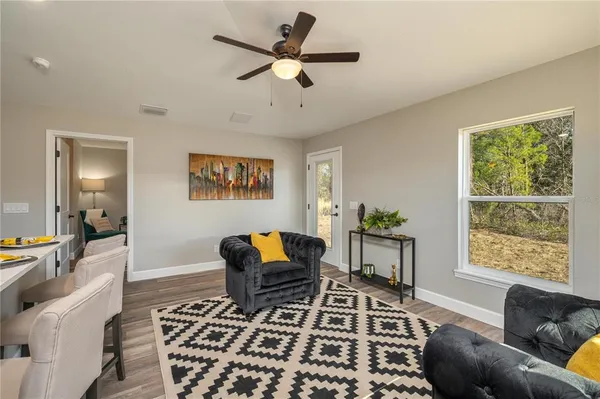 a kitchen with a table chairs refrigerator and cabinets